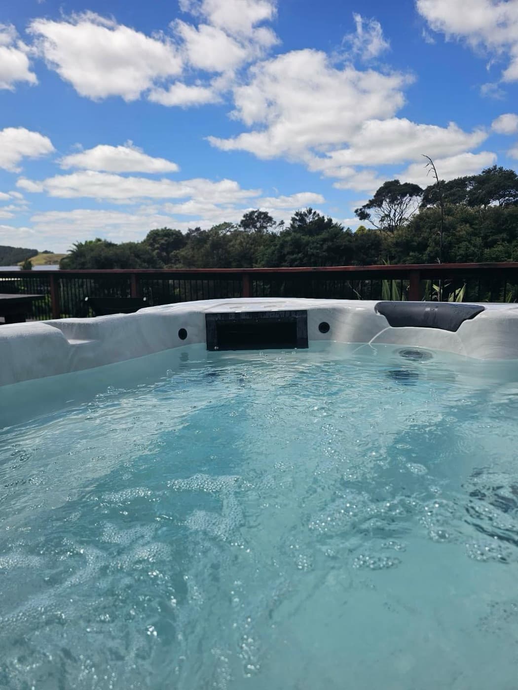 The private spa pool at Black Barn Valley Retreat, with native bush beyond the deck